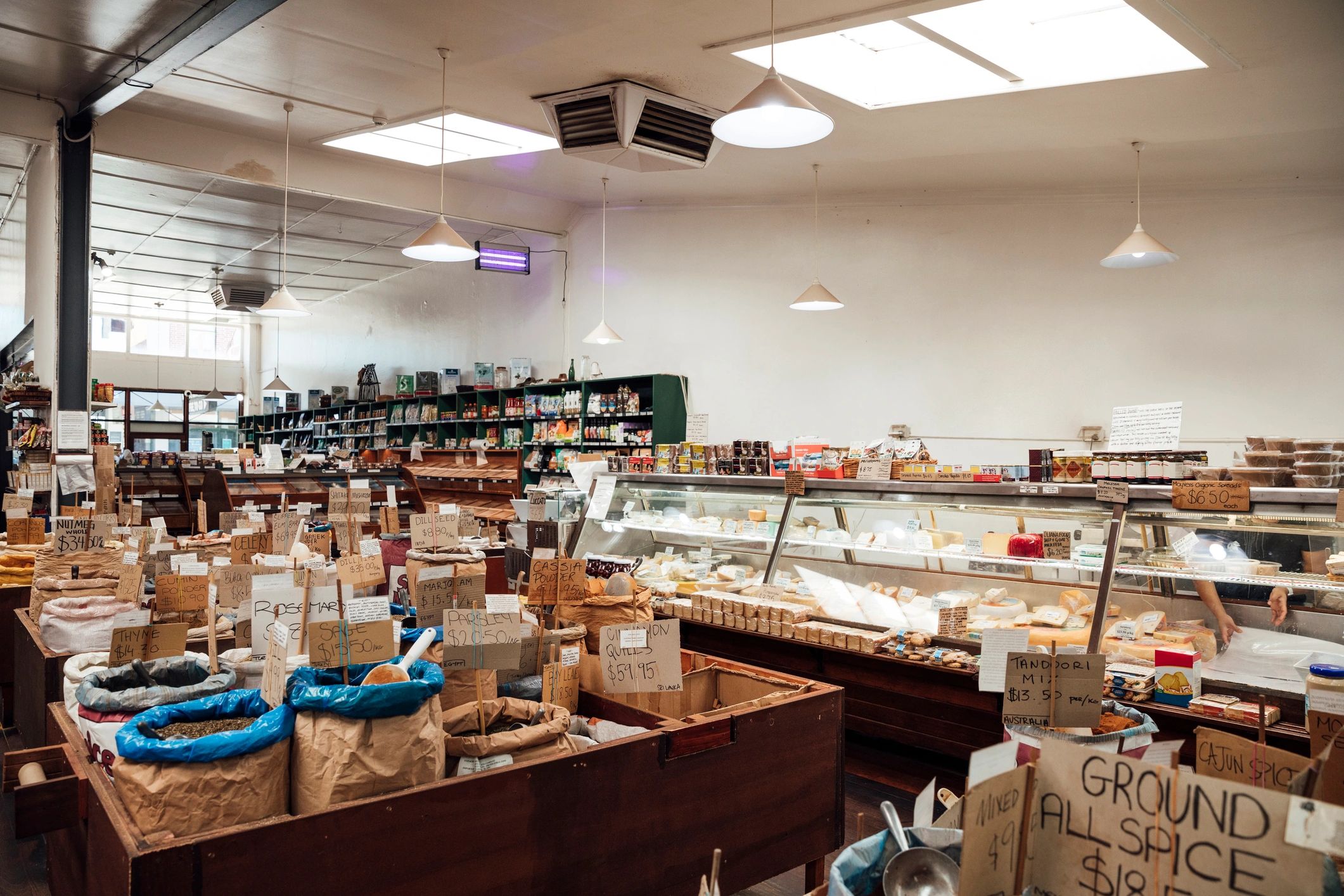 Wide view of a modern supermarket with fresh produce displays