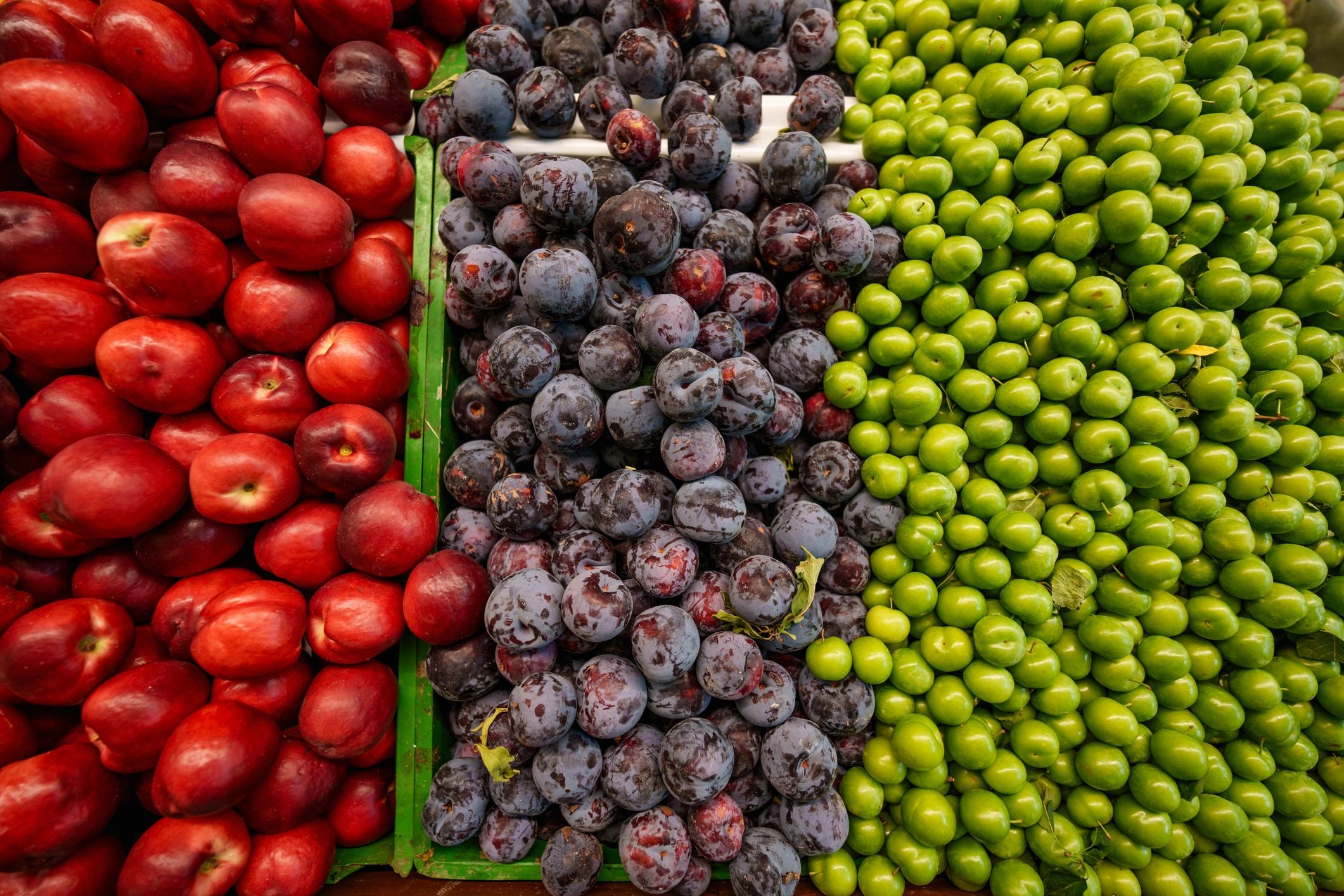 Fresh peaches and plums on produce display